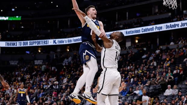 Denver Nuggets guard Christian Braun (0) drives to the net against Brooklyn Nets forward Harry Giles III (14)